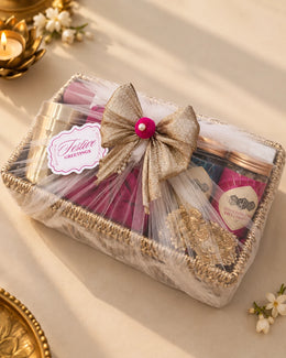 The same tray wrapped in sheer tulle with a gold bow and Festive Greetings tag, ready to gift — Tattva Diwali gift hamper